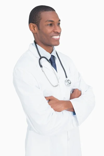 Smiling male doctor standing with arms crossed Stock Photo