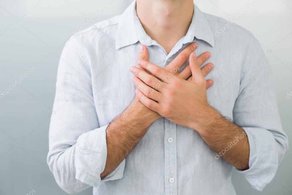 Mid section of a man with chest pain