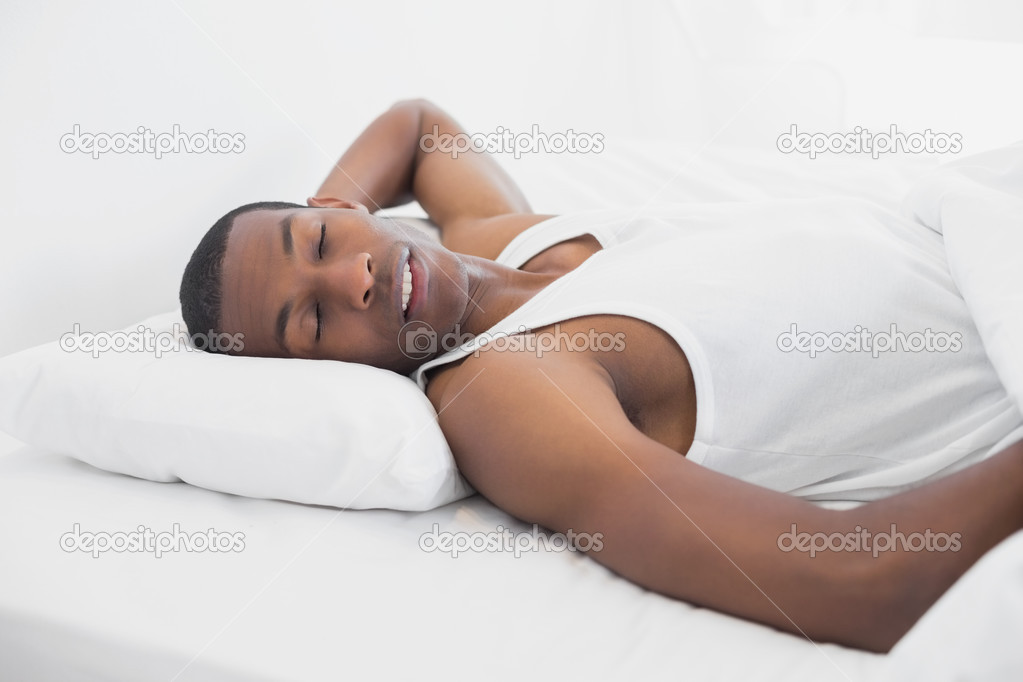 Afro man sleeping in bed