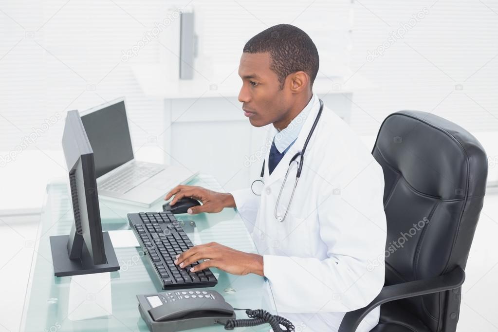 Doctor using computer at medical office