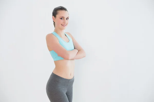 Portrait of toned woman standing against wall — Stock Photo, Image