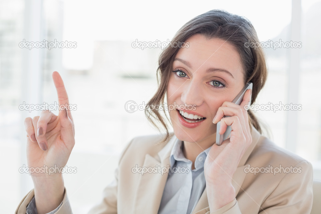 Smiling elegant businesswoman using mobile phone