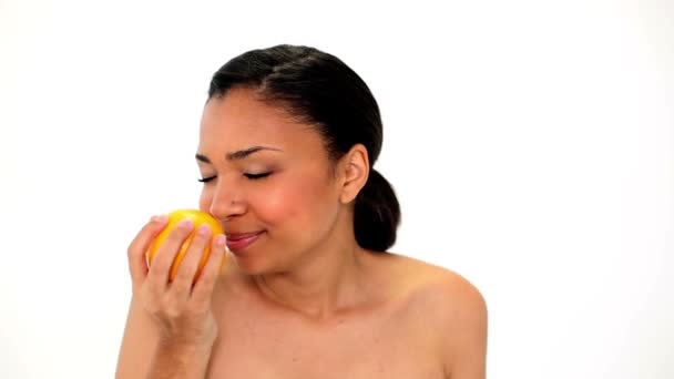 Cute laughing woman holding orange — Stock Video