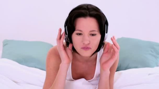 Happy enjoying woman listening with headphones to music — Stock Video