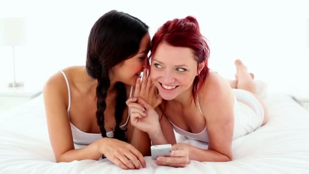 Pretty gleeful women text messaging with smartphone — Stock Video