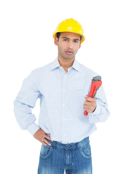 Handsome young handyman holding pipe wrench — Stockfoto