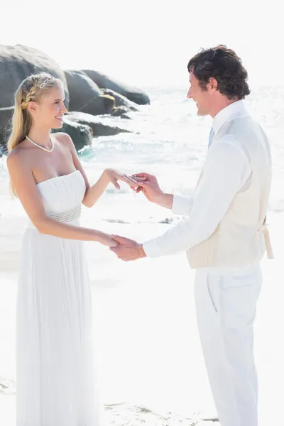 Man placing ring on pretty brides finger — Stock Photo, Image