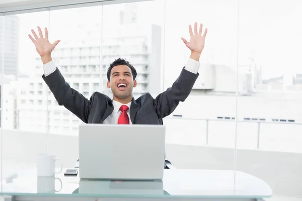 Empresario animando delante de la computadora portátil en el escritorio de la oficina — Foto de Stock