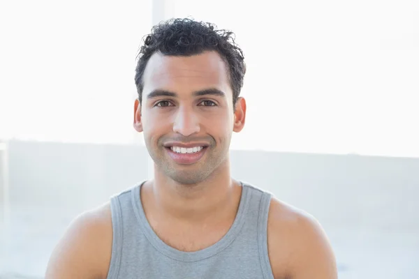 Close-up portrait of a smiling young man in vest — Stock Photo, Image