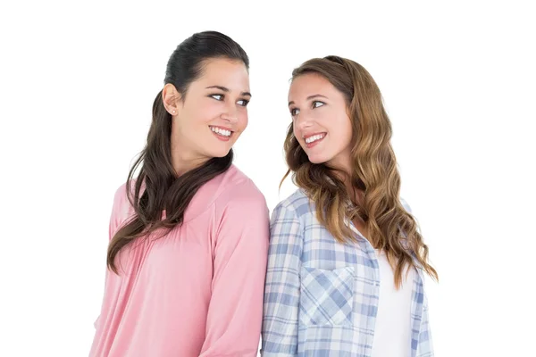 Happy young female friends standing back to back — Stock Photo, Image