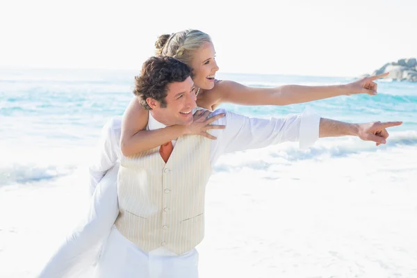 Newlyweds pointing to something and smiling — Stock Photo, Image