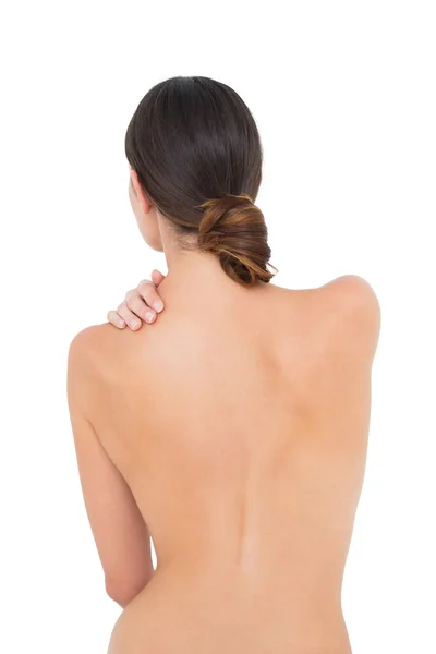 Rear view of a topless fit woman with shoulder pain — Stock Photo, Image