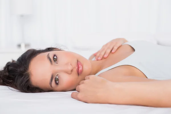 Pretty young woman relaxing in bed — Stock Photo, Image