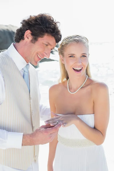 Hombre colocando anillo en el dedo de las novias felices —  Fotos de Stock