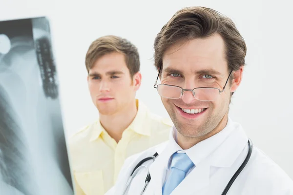 Concentrated doctor and patient examining lungs x-ray — Stock Photo, Image