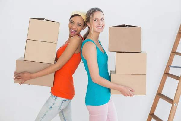 Vrouwelijke vrienden samen bewegen in een nieuw huis — Stockfoto