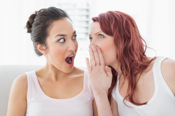 Close-up of young female friends gossiping at home — Stock Photo, Image