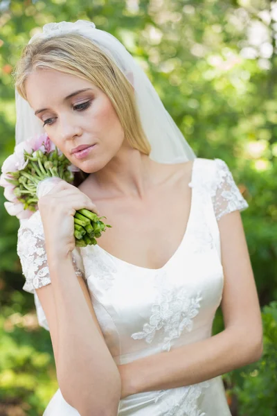 Vreedzame bruid houden haar boeket dragen een sluier — Stockfoto