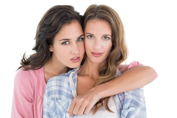 Young female embracing her friend from behind — Stock Photo, Image