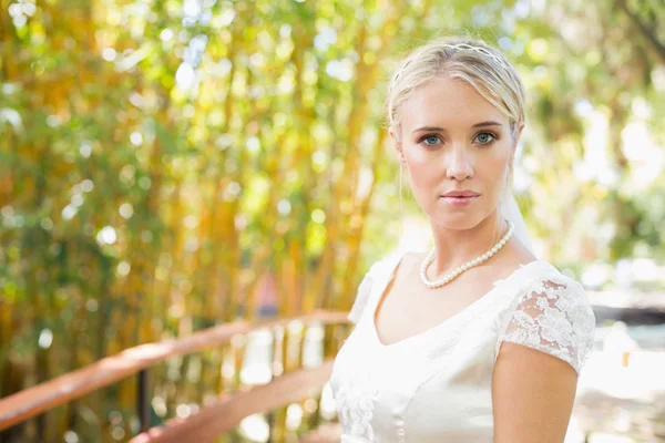 Smiling blonde bride in pearl necklace looking at camera — Stock Photo, Image