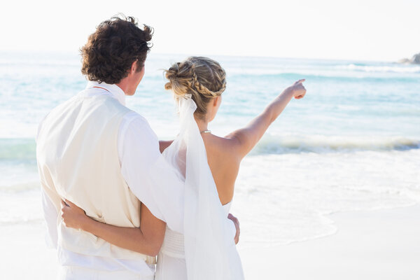 Newlyweds standing by the sea