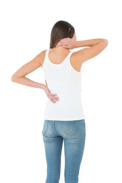 Rear view of a casual woman suffering from neck ache — Stock Photo, Image