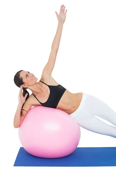 Fit young woman stretching on fitness ball — Stock Photo, Image
