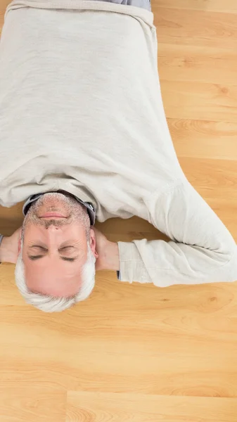 Overhead view of a man sleeping on parquet floor — Stock Photo, Image