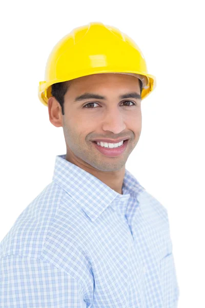 Portrait of a smiling handyman wearing a yellow hard hat — Stock Photo, Image