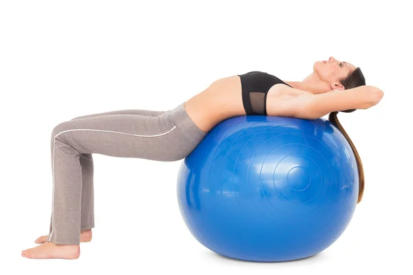 Side view of a fit woman stretching on fitness ball — Stock Photo, Image