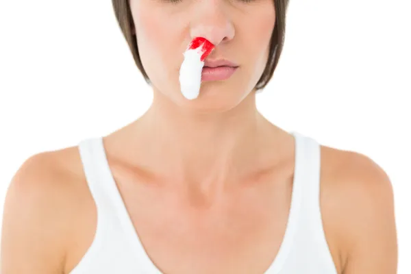 Close-up of a young woman with bleeding nose — Stock Photo, Image