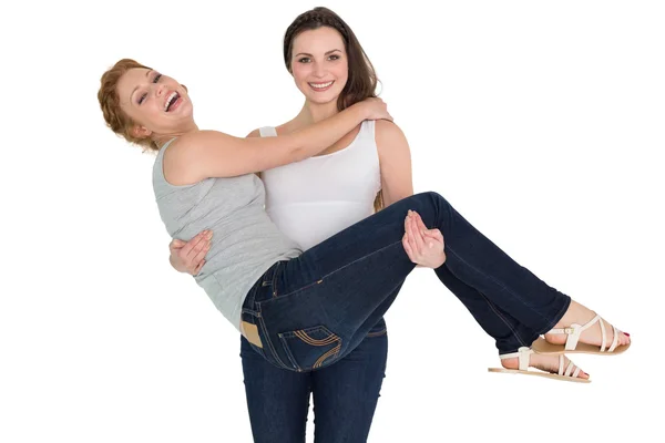 Portrait of a young female carrying her cheerful friend — Stock Photo, Image