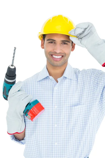 Smiling handsome young handyman in hard had with drill — Stock Photo, Image
