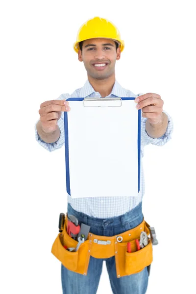 Smiling handyman in yellow hard hat holding clipboard Royalty Free Stock Photos