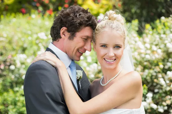 Romantic smiling newlyweds hugging each other Stock Image