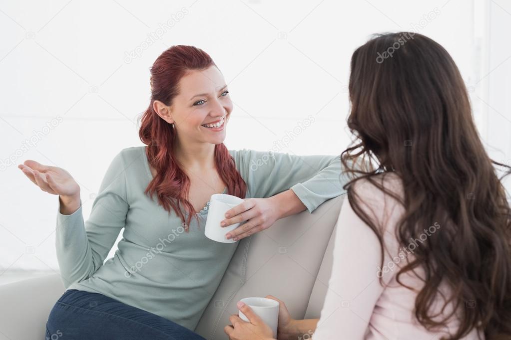 Female friends enjoying a chat over coffee at home