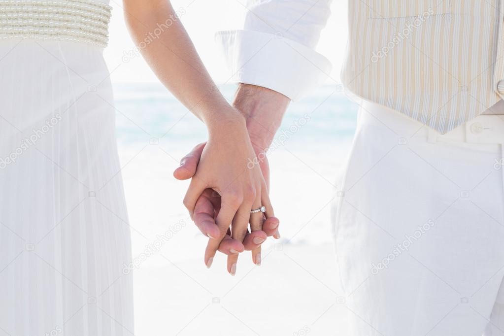 Newlyweds holding hands close up