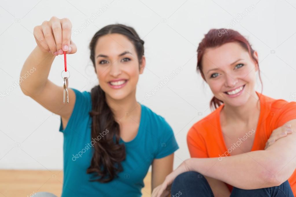 Female friends with keys in new house