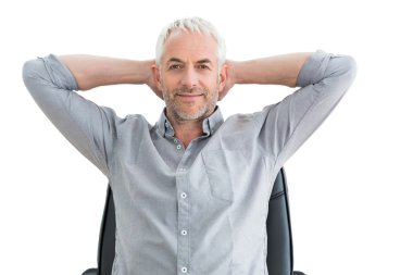 Relaxed mature businessman with hands behind head clipart