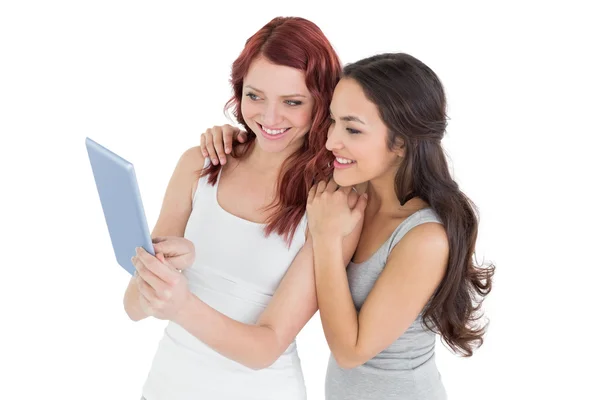 Casual young female friends looking at digital tablet — Stock Photo, Image