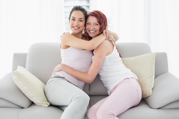Happy female embracing her friend at home — Stock Photo, Image