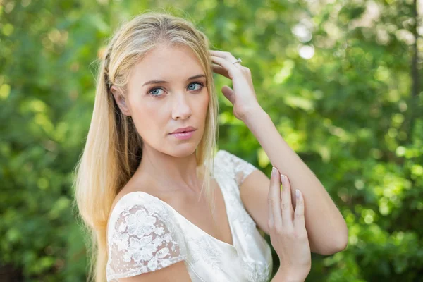 Content beautiful bride touching her hair — Stock Photo, Image