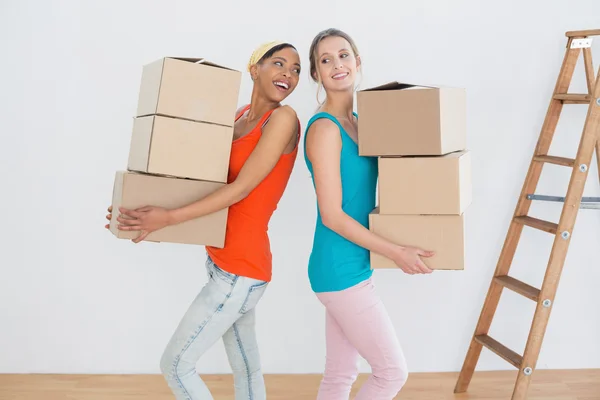 Cheerful friends moving together in a new house — Stock Photo, Image