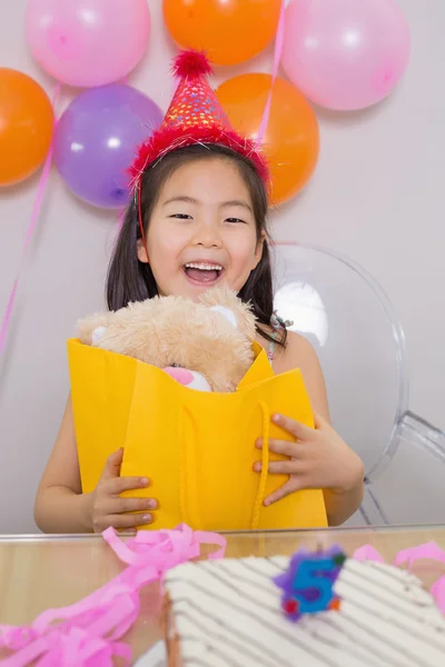 Cheerful surprised little girl at her birthday party — Stock Photo, Image