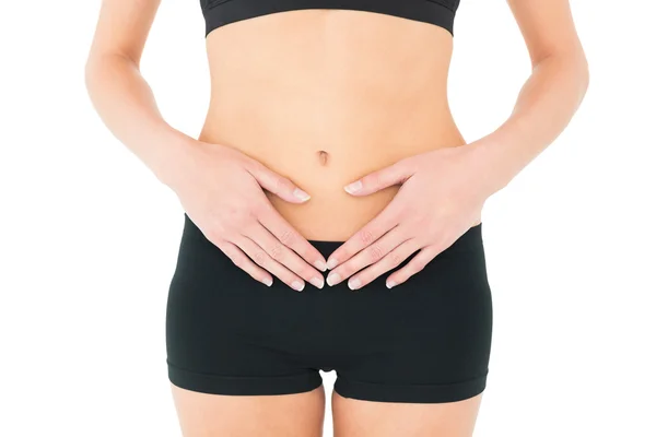 Acercamiento sección media de una mujer en forma con dolor de estómago — Foto de Stock