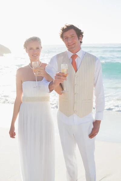 Grillage de jeunes mariés avec champagne souriant à la caméra — Photo