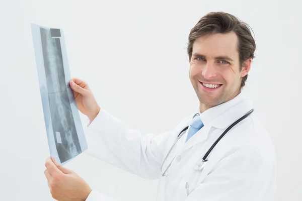 Portrait of a male doctor examining spine x-ray — Stock Photo, Image