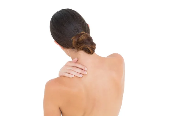 Close-up visão traseira de uma mulher de topless com dor no ombro — Fotografia de Stock