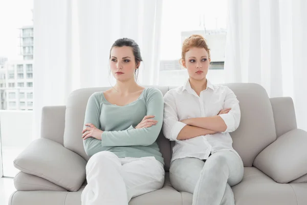 Unhappy friends not talking after argument on the couch — Stock Photo, Image