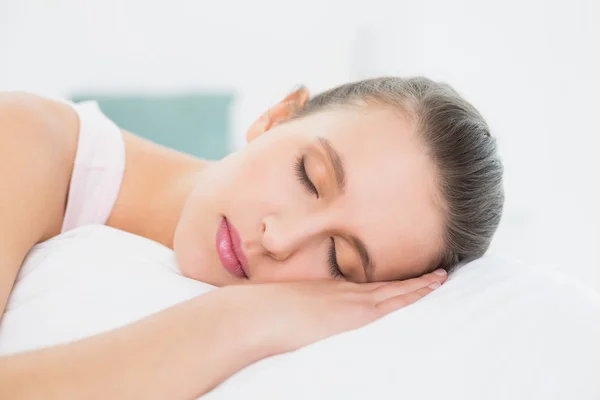 Mooie vrouw slapen met de ogen gesloten in bed — Stockfoto